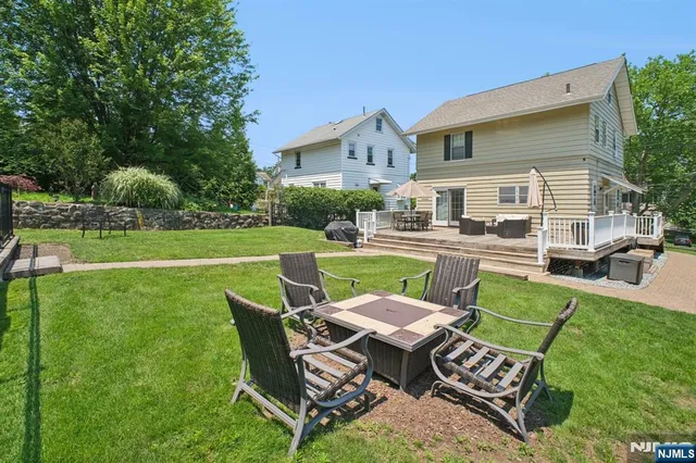 a view of a chair and table in the grass
