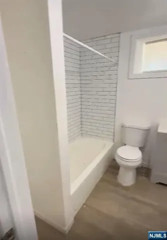 a bathroom with a toilet and a bathtub