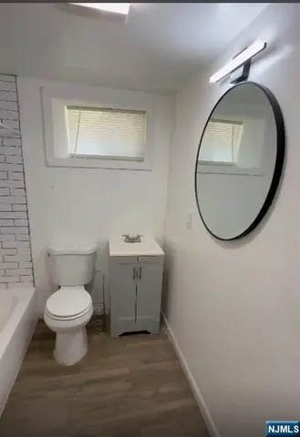 a bathroom with a toilet sink and a mirror