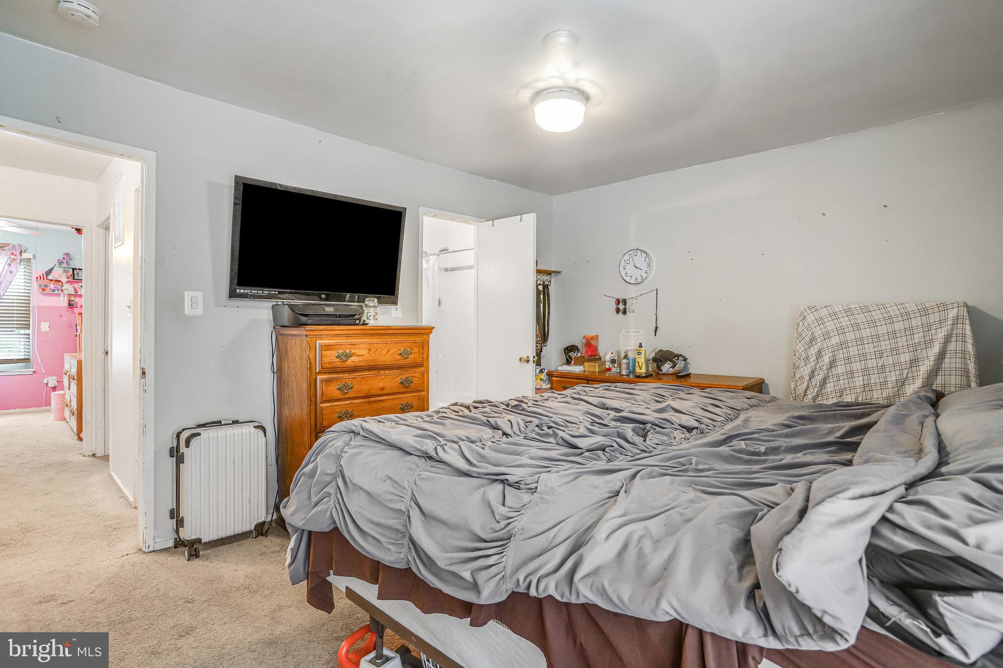 24 Mountaingate Drive Frederick, MD 21703 - Photo 22 of 32 a bedroom with a bed and a flat screen tv