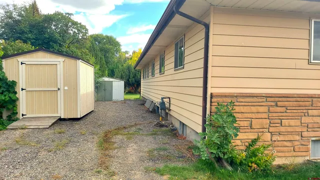 a view of a house with a yard and wooden fence