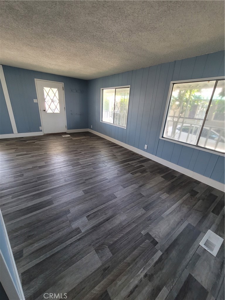 18151 Valley Boulevard, Unit 55 La Puente, CA 91744 - Photo 17 of 38 an empty room with wooden floor and windows