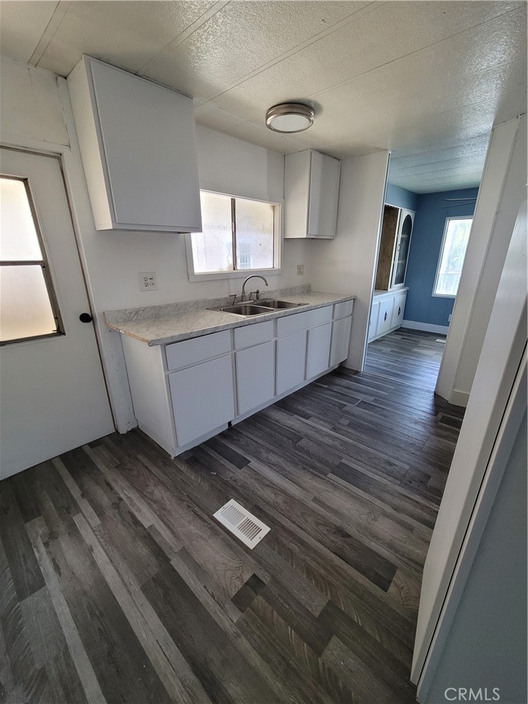 18151 Valley Boulevard, Unit 55 La Puente, CA 91744 - Photo 18 of 38 a kitchen with sink and cabinets