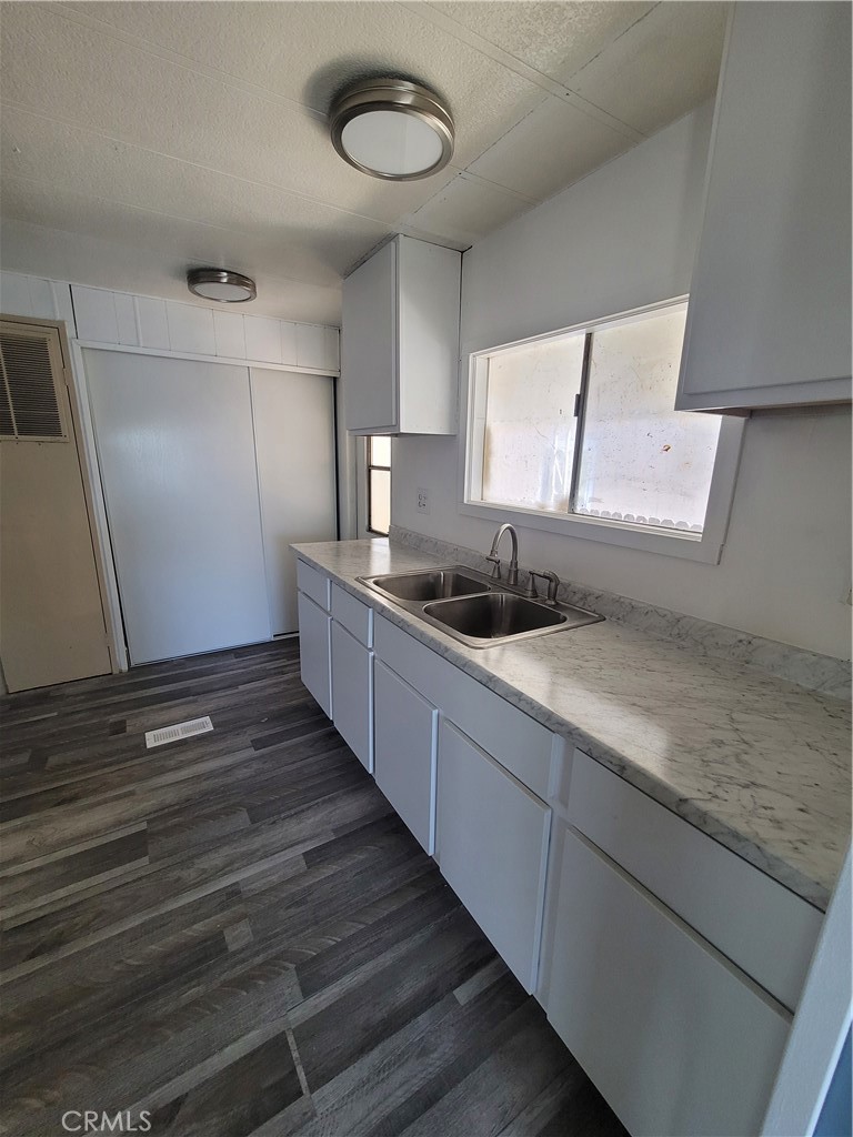 18151 Valley Boulevard, Unit 55 La Puente, CA 91744 - Photo 20 of 38 a kitchen with sink window and cabinets