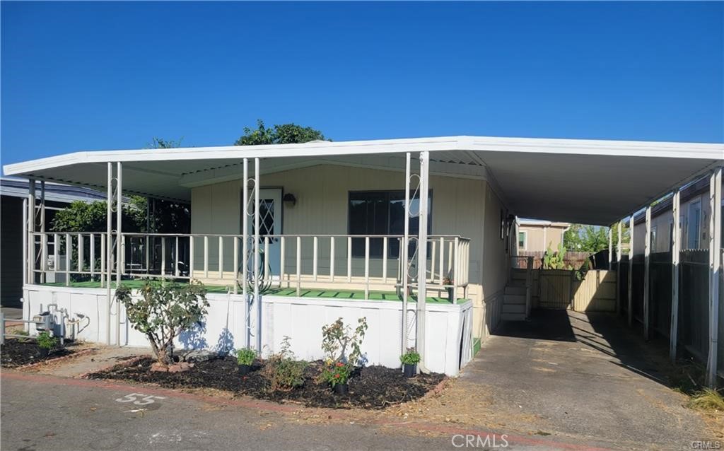 18151 Valley Boulevard, Unit 55 La Puente, CA 91744 - Photo 2 of 38 a front view of a house with a porch