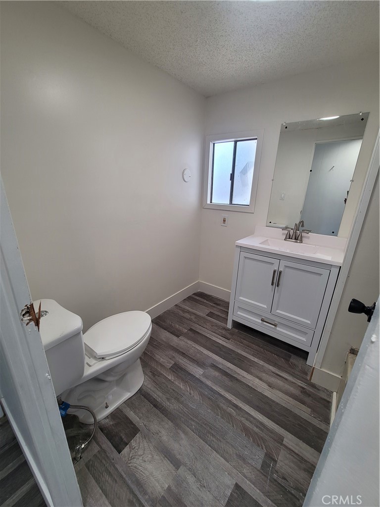18151 Valley Boulevard, Unit 55 La Puente, CA 91744 - Photo 25 of 38 a bathroom with a toilet a sink and mirror