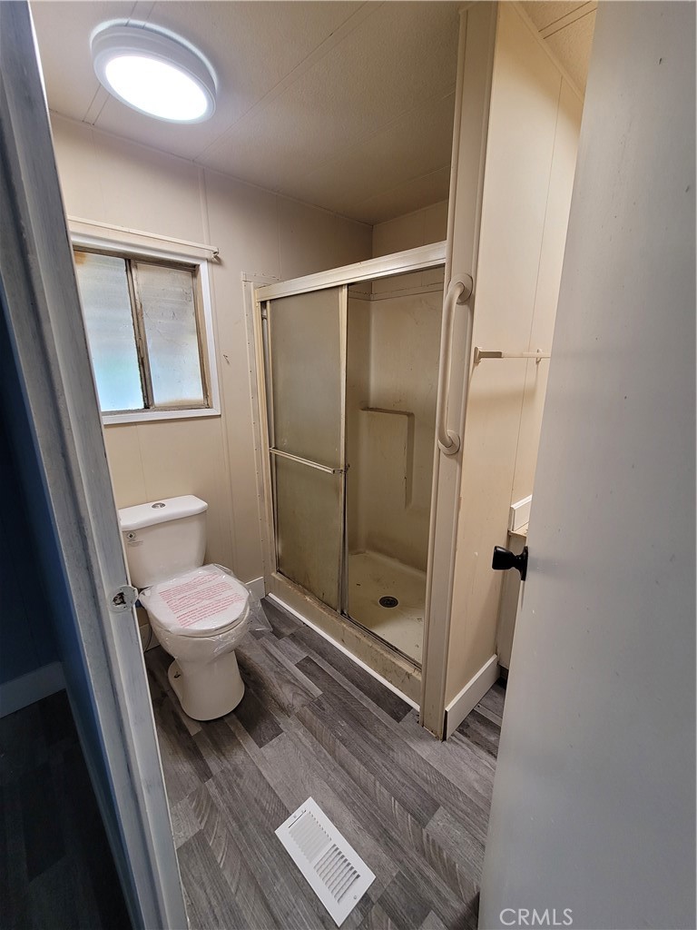 18151 Valley Boulevard, Unit 55 La Puente, CA 91744 - Photo 27 of 38 a bathroom with a toilet and a shower