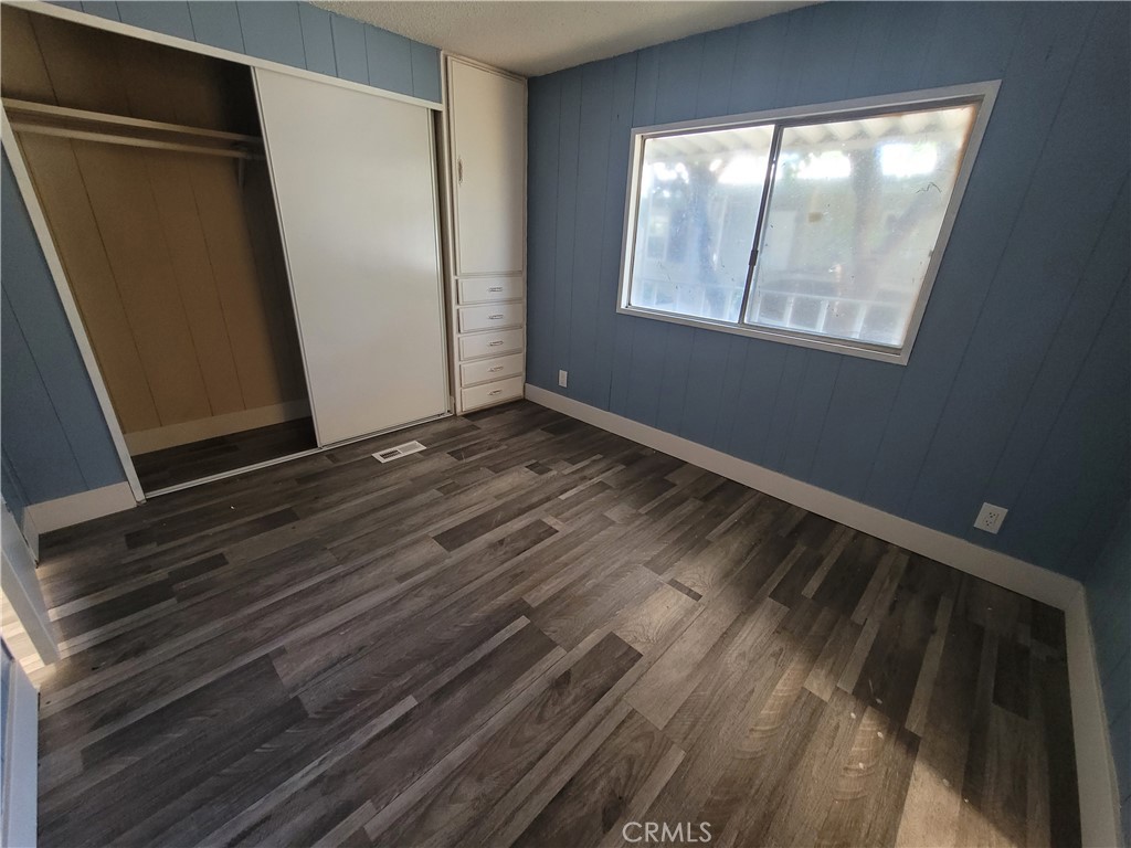 18151 Valley Boulevard, Unit 55 La Puente, CA 91744 - Photo 28 of 38 a view of an empty room with wooden floor and a window