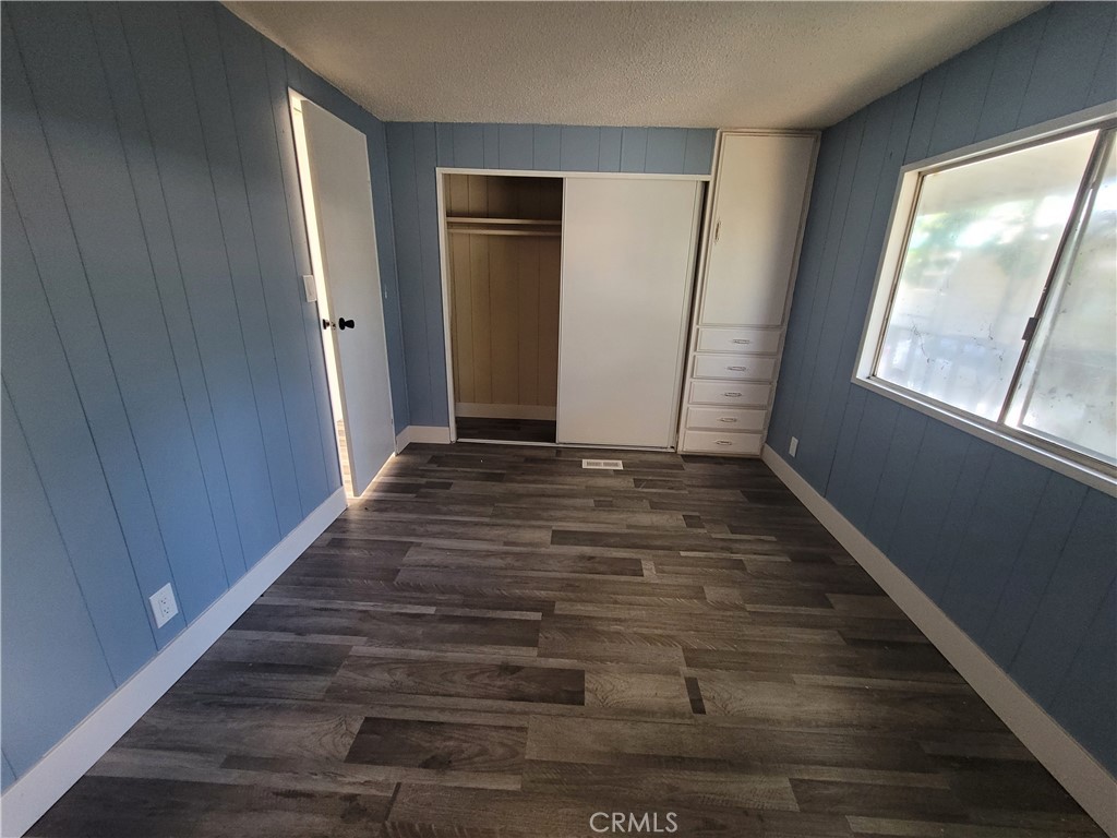 18151 Valley Boulevard, Unit 55 La Puente, CA 91744 - Photo 29 of 38 a view of an empty room with wooden floor and a window