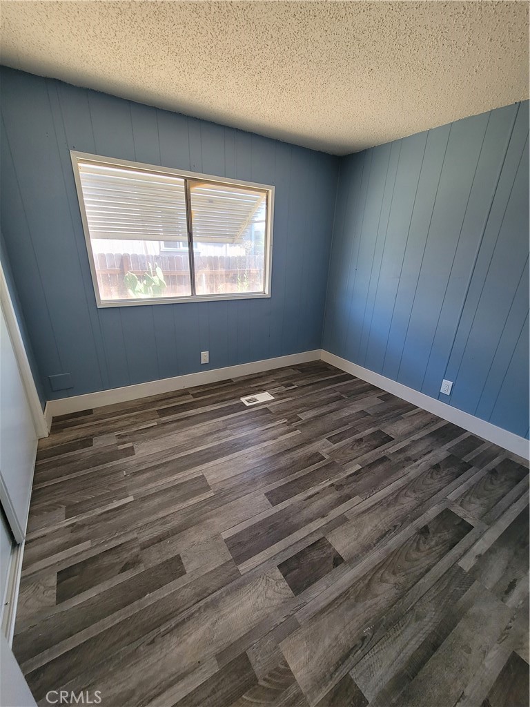 18151 Valley Boulevard, Unit 55 La Puente, CA 91744 - Photo 31 of 38 a view of an empty room with wooden floor and a window