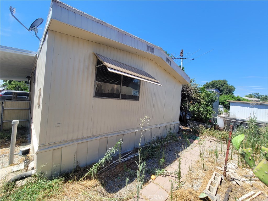 18151 Valley Boulevard, Unit 55 La Puente, CA 91744 - Photo 6 of 38 a backyard of a house with a large tree