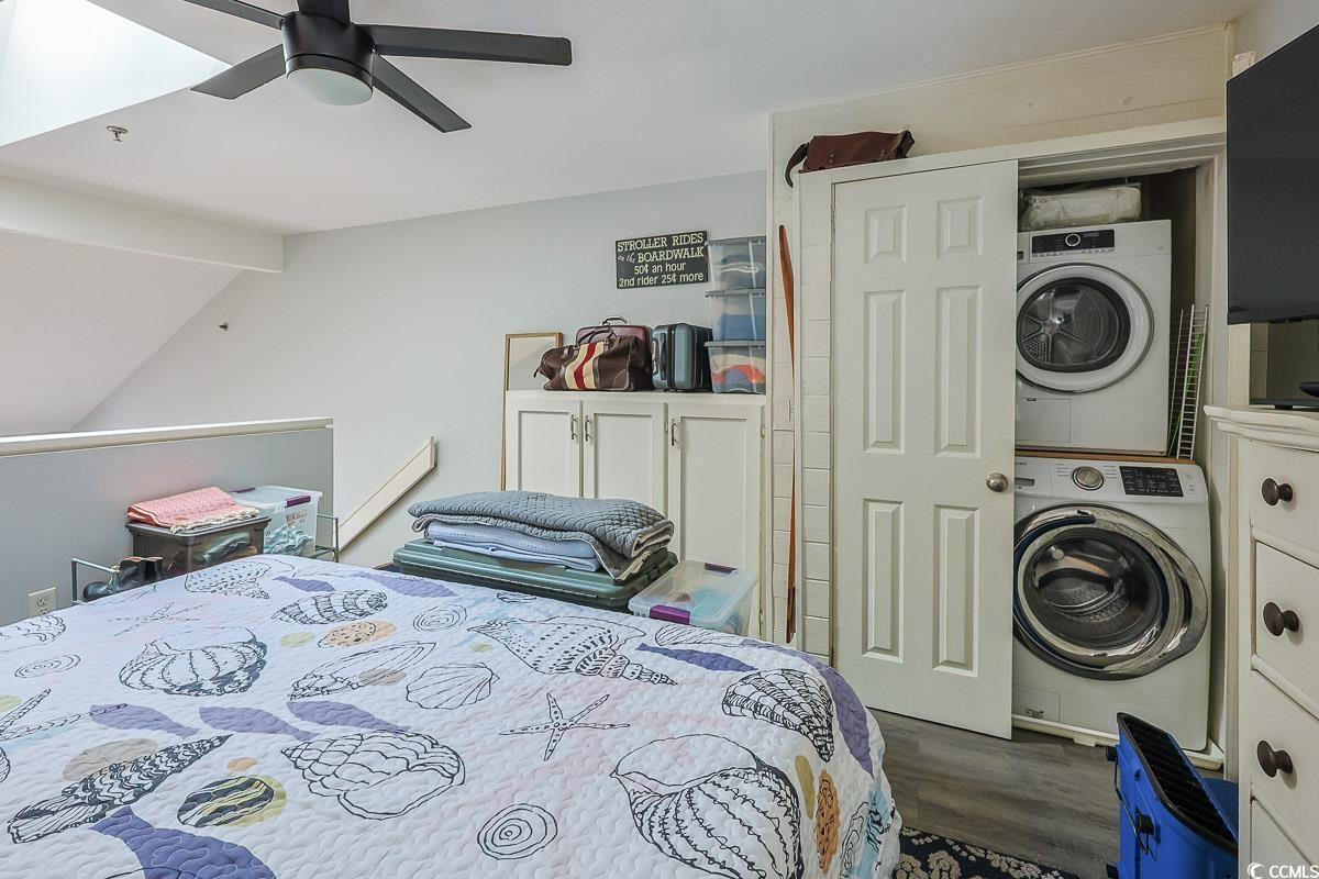 1100 Possum Trot Road, Unit G324 North Myrtle Beach, SC 29582 - Photo 17 of 28 Bedroom featuring dark wood-style floors, ceiling fan, estacked washer and dryer, and vaulted ceiling