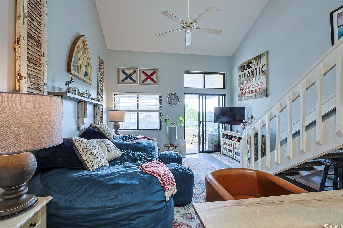 1100 Possum Trot Road, Unit G324 North Myrtle Beach, SC 29582 - Photo 6 of 28 Living room with high vaulted ceiling, ceiling fan, and stairs