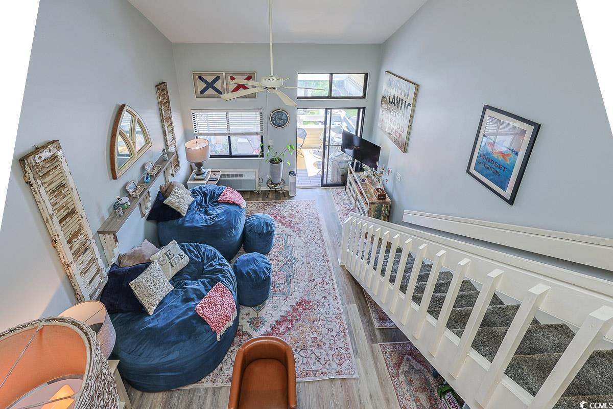 1100 Possum Trot Road, Unit G324 North Myrtle Beach, SC 29582 - Photo 7 of 28 Living area with wood finished floors, a towering ceiling, and ceiling fan