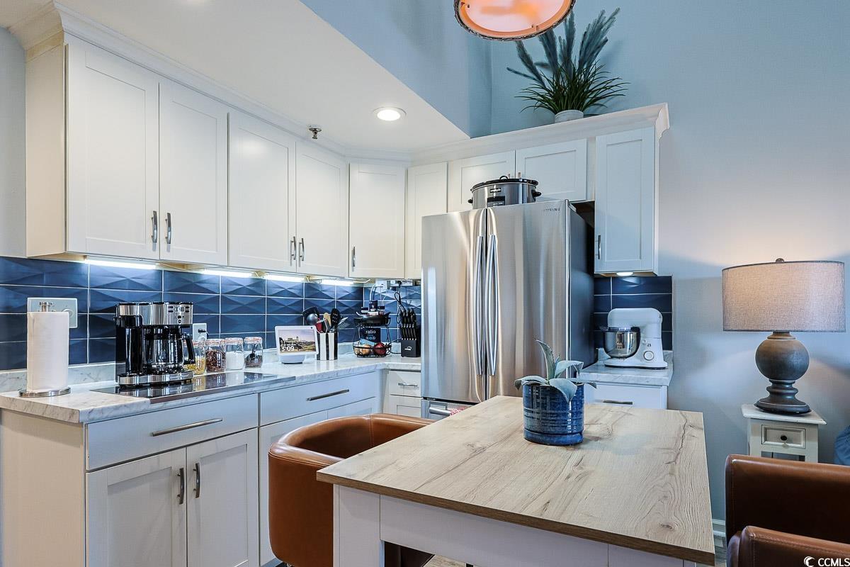 1100 Possum Trot Road, Unit G324 North Myrtle Beach, SC 29582 - Photo 8 of 28 Kitchen featuring freestanding refrigerator, decorative backsplash, white cabinetry, and recessed lighting