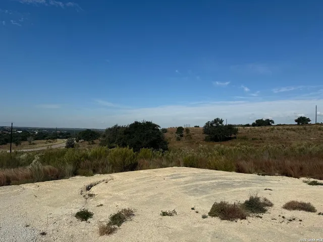 a view of a dry yard with a lake view