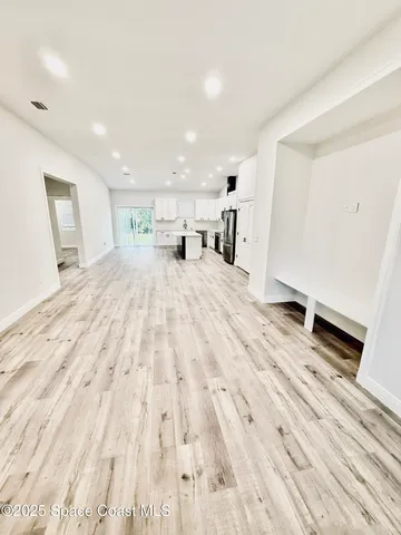 a large room with a bed and glass door