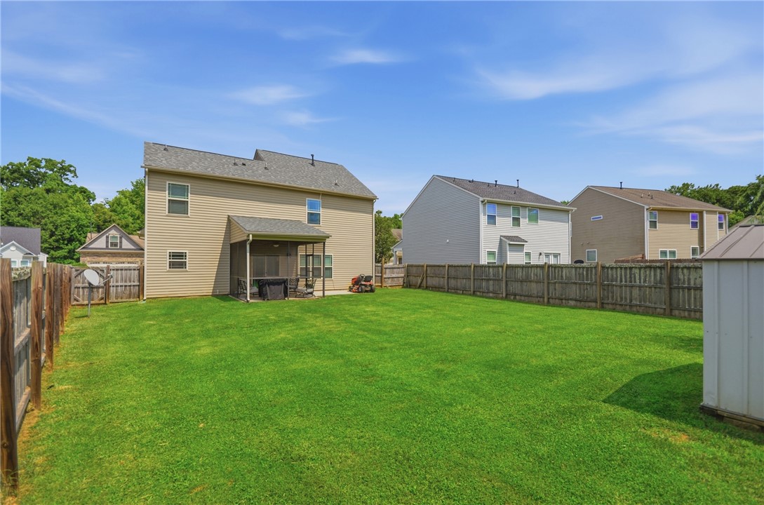 347 Riverdale Road Simpsonville, SC 29680 - Photo 26 of 30 A deep backyard offers privacy and room for recreation, featuring a covered patio and a detached storage shed.