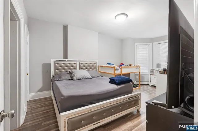 a view of a two room with wooden floor and windows