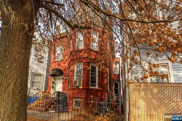 a kitchen with granite countertop lots of clutter and stainless steel appliances