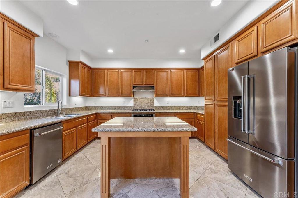 2252 Marquand Court Alpine, CA 91901 - Photo 11 of 45 a kitchen with stainless steel appliances granite countertop a sink stove and refrigerator