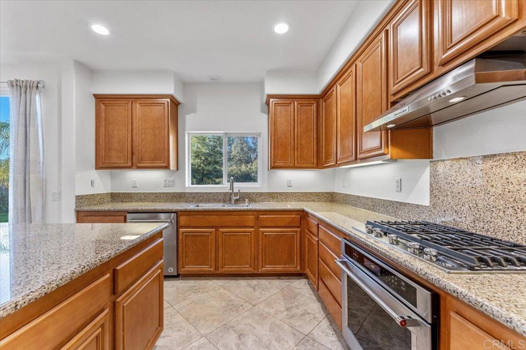 2252 Marquand Court Alpine, CA 91901 - Photo 12 of 45 a kitchen with stainless steel appliances granite countertop a sink stove top oven and cabinets