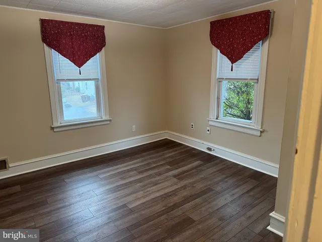 a view of a balcony with wooden floor