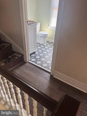 a balcony with wooden floor and yard in the back