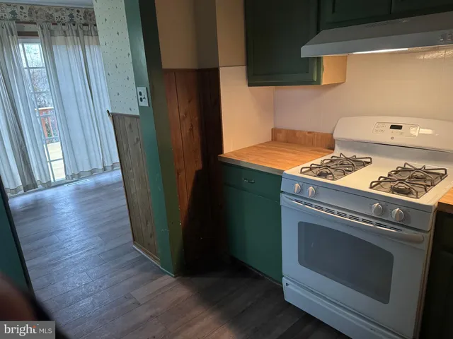 a bathroom with a granite countertop sink toilet and a mirror