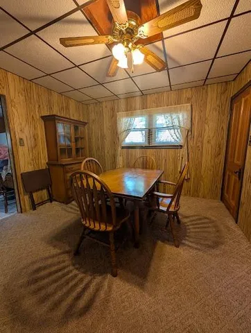 a living room with a couch and a refrigerator