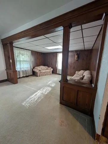 a bedroom with a bed and a mirror on dresser