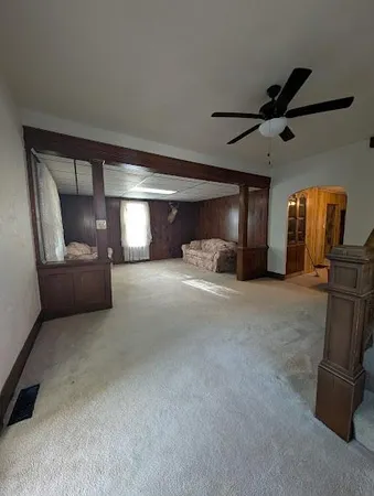 a bedroom with a bed and a car