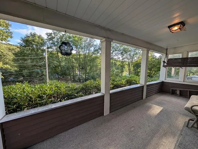 a view of two chairs in the balcony