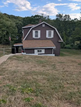 a view of a house with a yard and a wooden fence