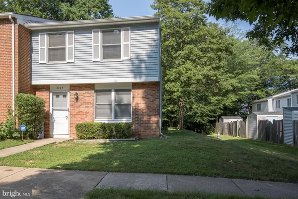 a view of a house with a yard and plants