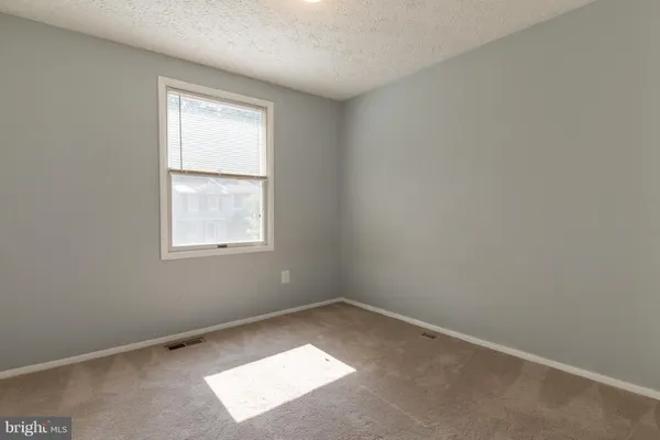 a bathroom with a granite countertop sink mirror vanity and toilet