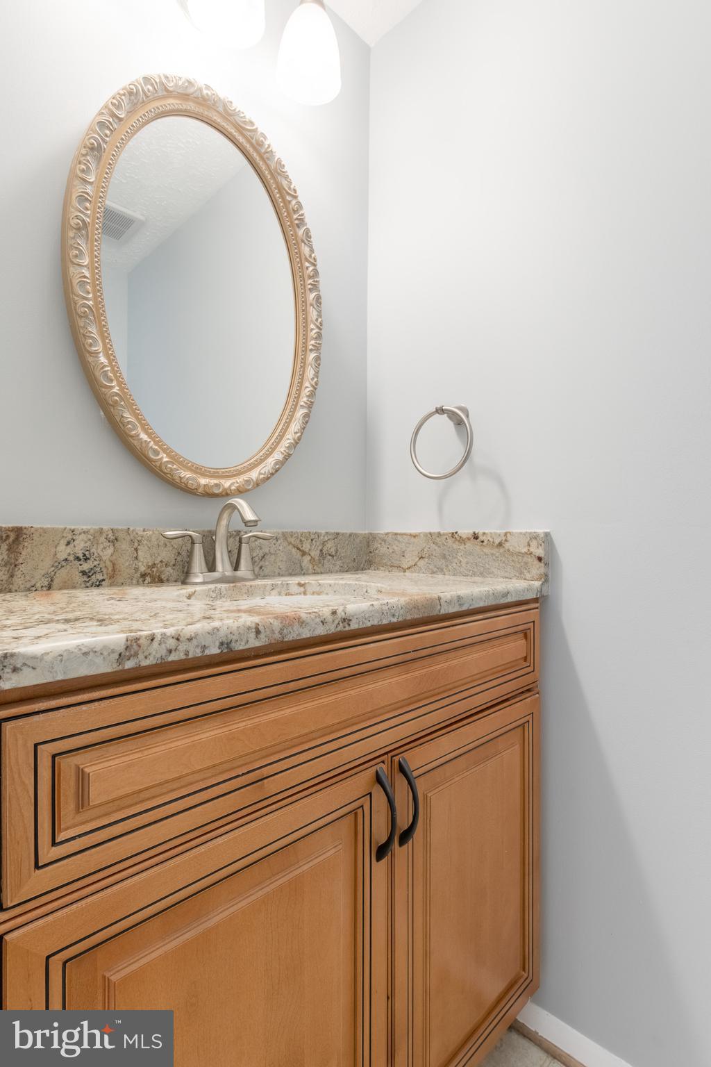 8334 Windfall Road Springfield, VA 22153 - Photo 10 of 16 a bathroom with a granite countertop sink and mirror