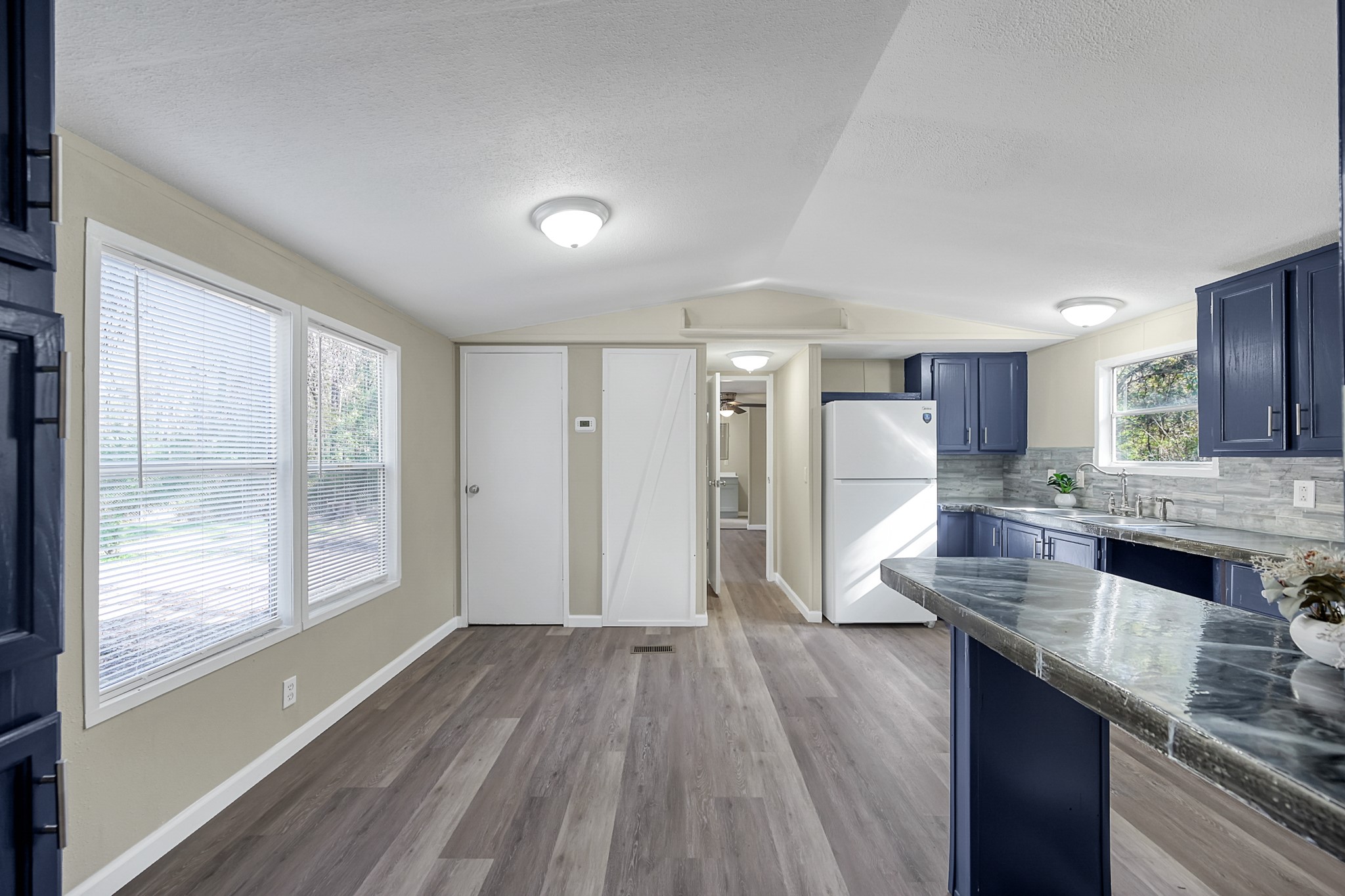 13219 13th Street, Unit A Splendora, TX 77372 - Photo 11 of 19 Here we are just inside the front door where you'll see a small island/bar area as well as a space to put a formal dining table or breakfast table.