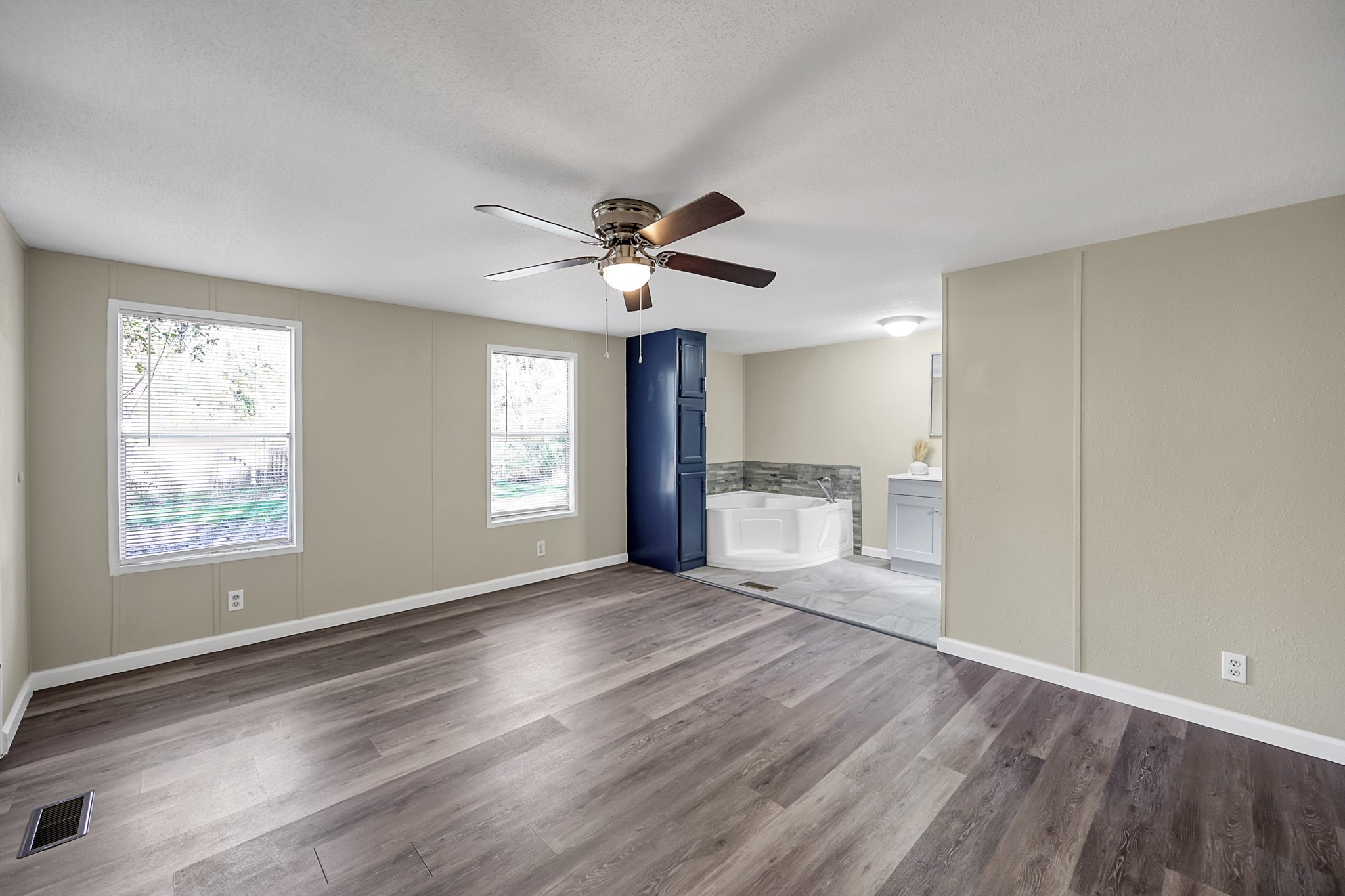 13219 13th Street, Unit A Splendora, TX 77372 - Photo 15 of 19 Your primary bedroom has tons of natural light, two closets, and a dreamy ensuite bathroom.