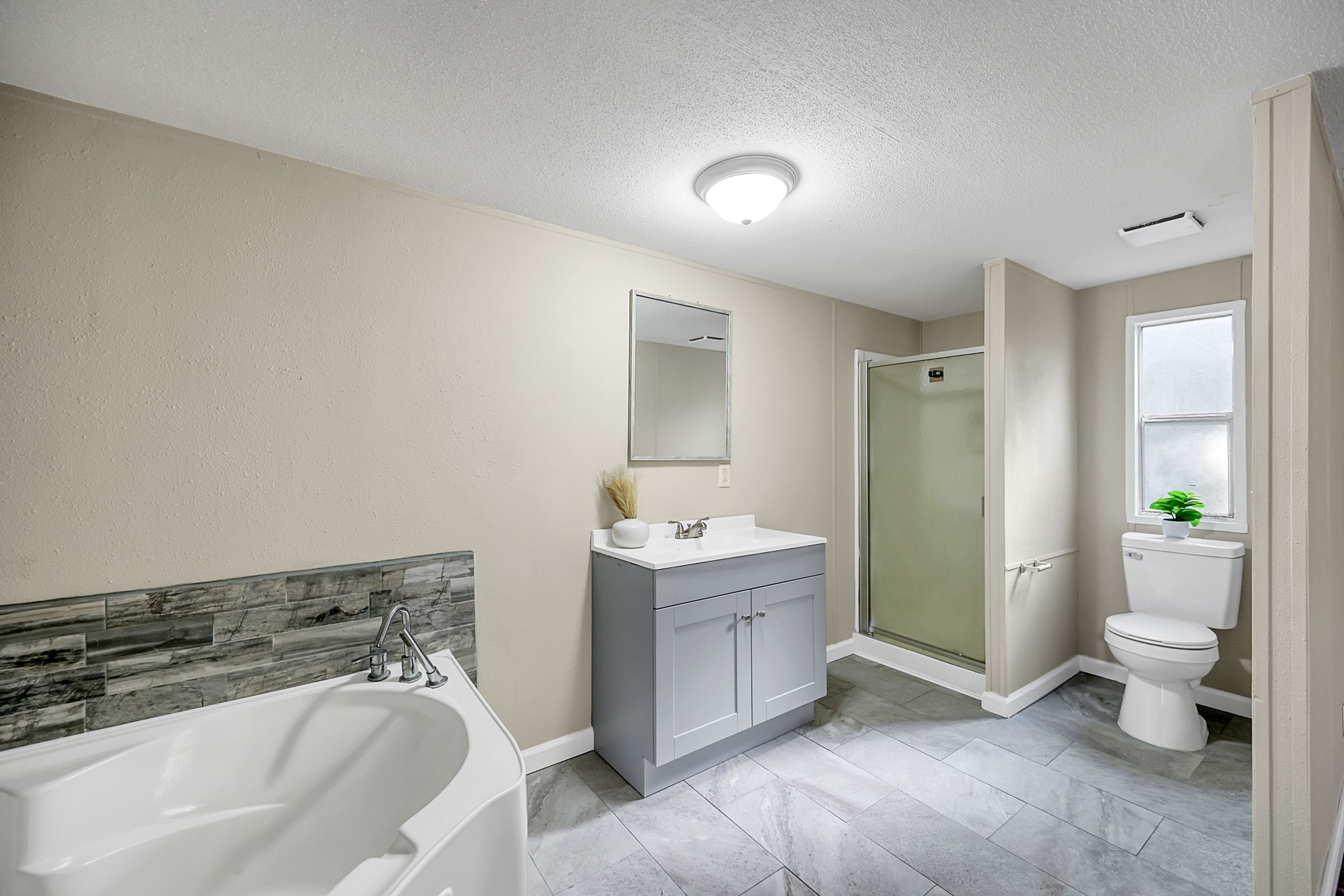 13219 13th Street, Unit A Splendora, TX 77372 - Photo 16 of 19 Enjoy a large soaker tub and walk in shower in your relaxing primary bathroom.