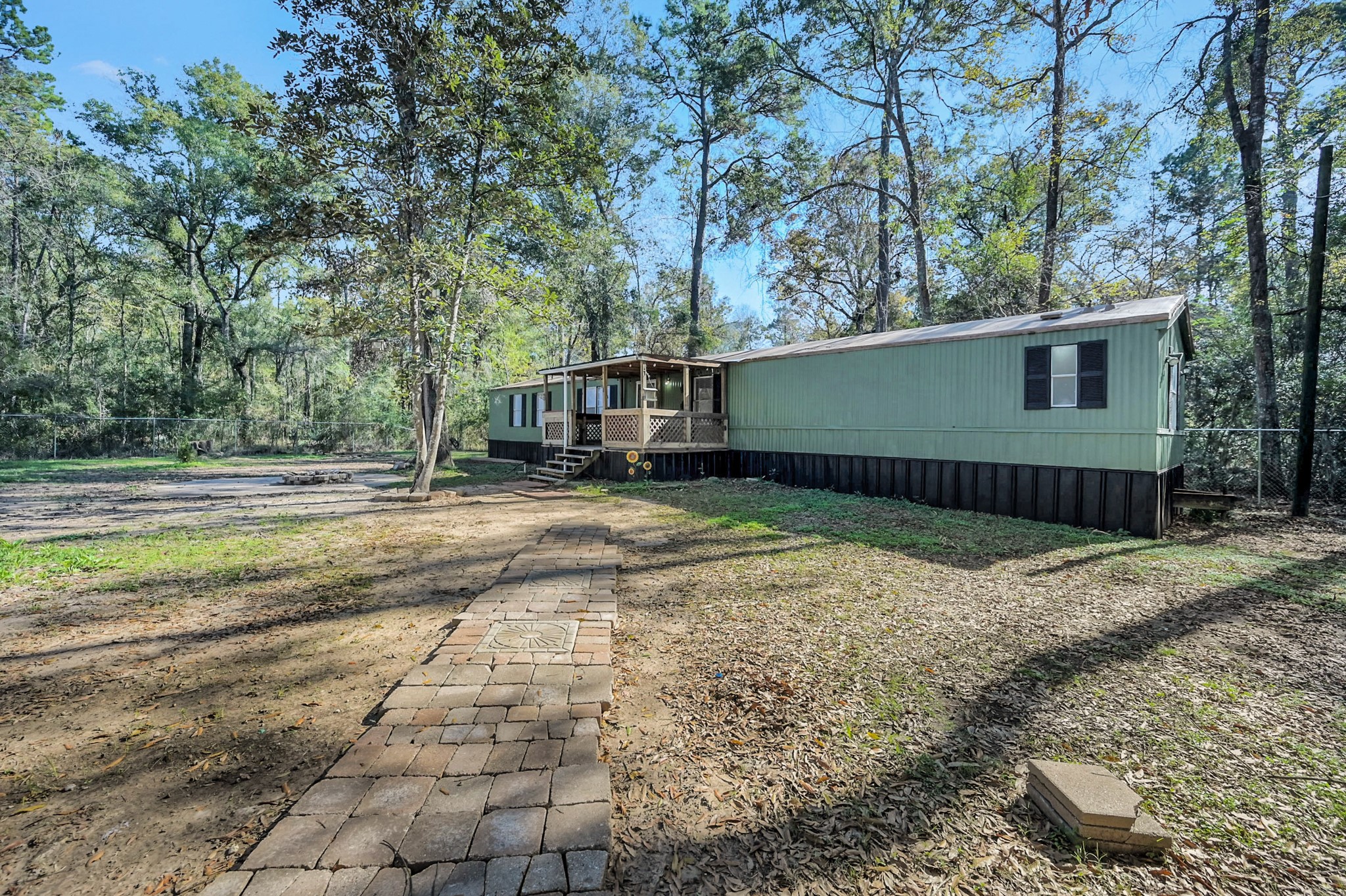 13219 13th Street, Unit A Splendora, TX 77372 - Photo 2 of 19 Enjoy a large fenced area around the home to keep people and pets playing outside confined.