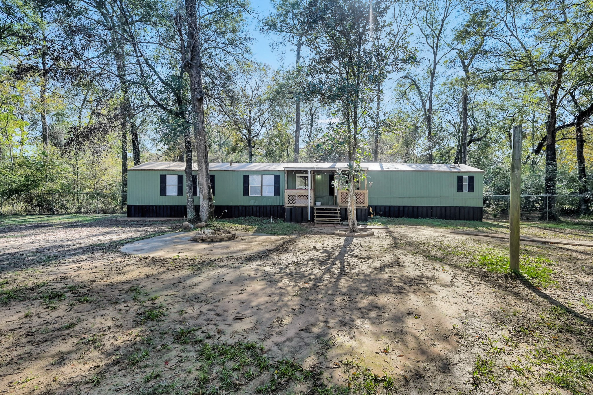 13219 13th Street, Unit A Splendora, TX 77372 - Photo 3 of 19 Check out this view showing just how large the yard is, the cleared area for a fire pit, and the beautiful front porch.