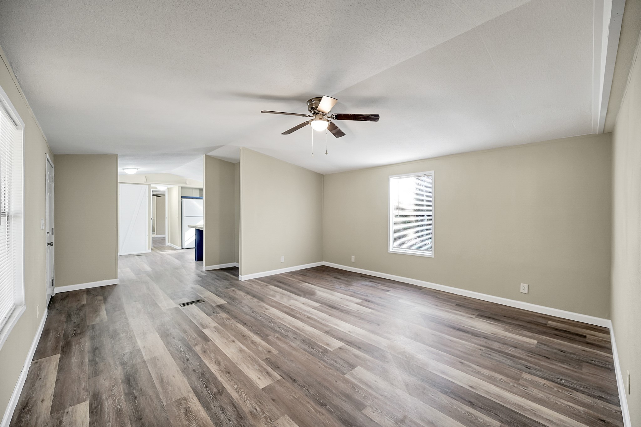 13219 13th Street, Unit A Splendora, TX 77372 - Photo 7 of 19 Here is another view showing the front door on the left, the dining space and kitchen ahead, and the primary bedroom on the other side of that. Behind you is a hallway with your secondary bedrooms and a bathroom. Let's turn around and check out the secondary bedrooms first.