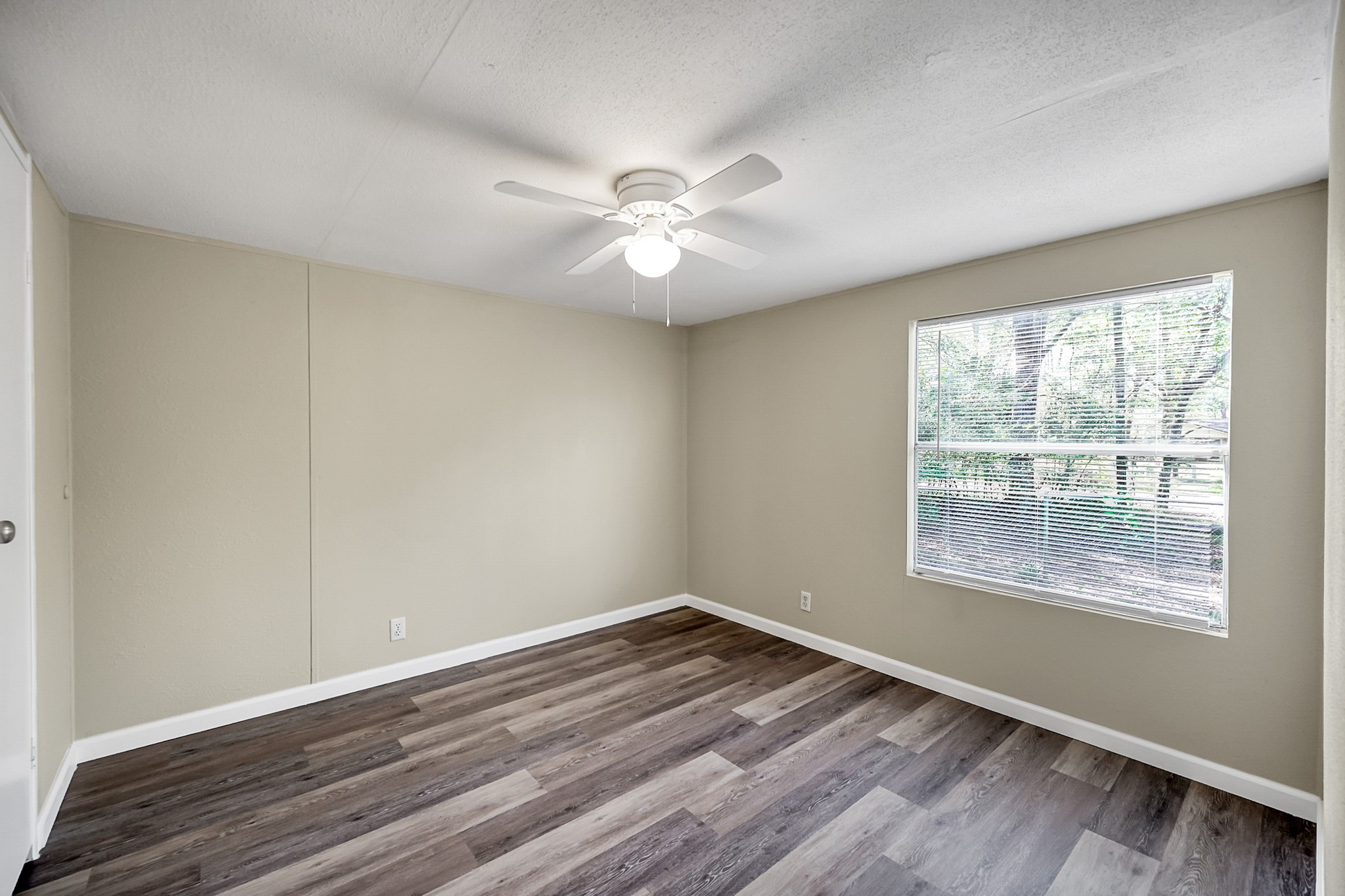 13219 13th Street, Unit A Splendora, TX 77372 - Photo 10 of 19 Here is another secondary bedroom with beautiful natural light streaming in. Now let's go back down the hallway and stop by the front door again