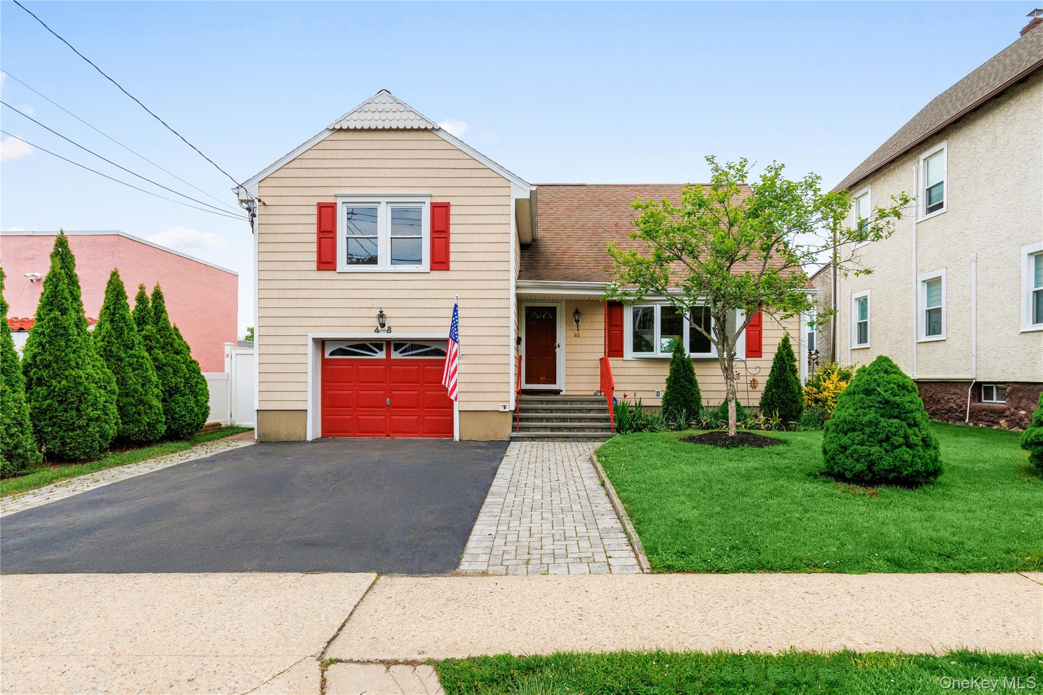 46 Mathews Street Harrison, NY 10528 - Photo 1 of 30 a front view of a house with a yard and a garage
