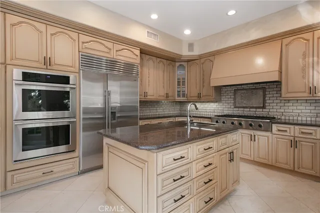 a kitchen with stainless steel appliances granite countertop a stove microwave and cabinets