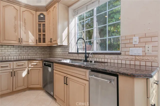 a kitchen with stainless steel appliances granite countertop a sink and a window
