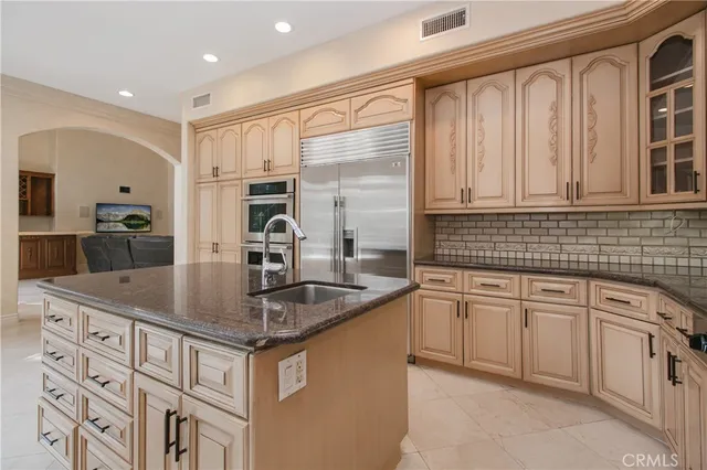 a kitchen with stainless steel appliances granite countertop a sink and dishwasher a stove with wooden floors