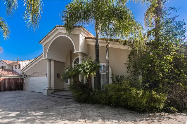 a front view of a house with plants