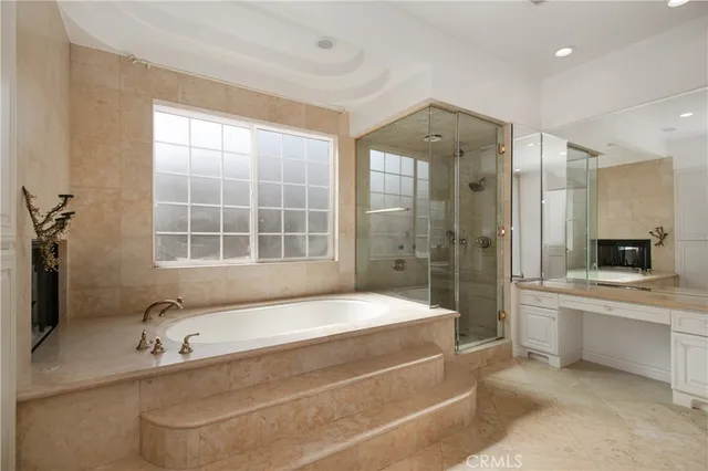 a bathroom with a bathtub and a shower